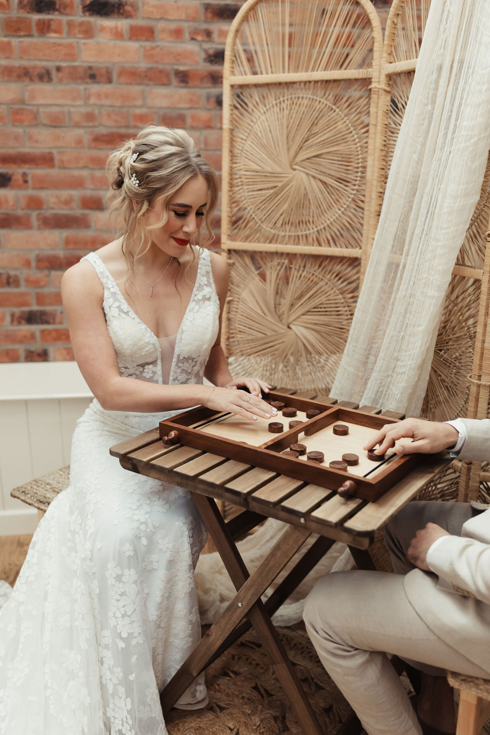 Bride and groom playing a game of pucket together on their wedding day, laughing and having fun. An indoor game available to hire from Emma Lane Designs