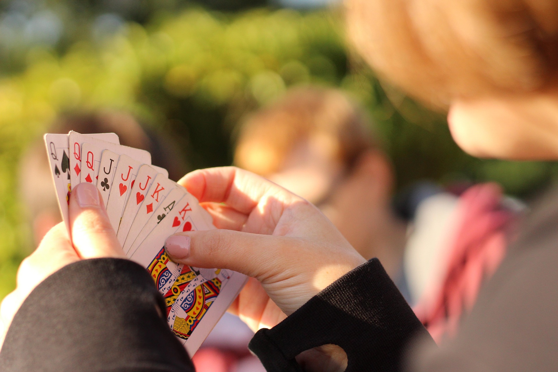 Holding a hand of playing cards | Card game ideas for couples