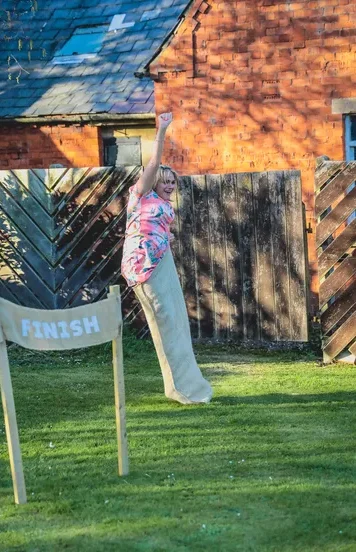Wedding guest playing sack races and is the winner