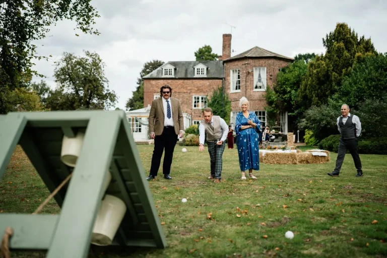 Wedding guests playing Ball in a Bucket game, whilst others watch