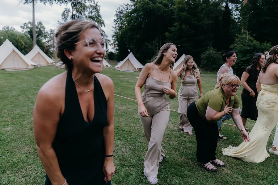 Wedding guests laughing and having fun playing wedding garden games
