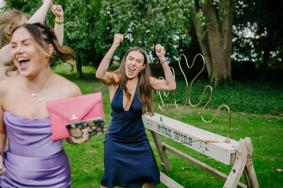 A wedding guest beating the Buzz Wire. One of the best games for weddings with competitive guests