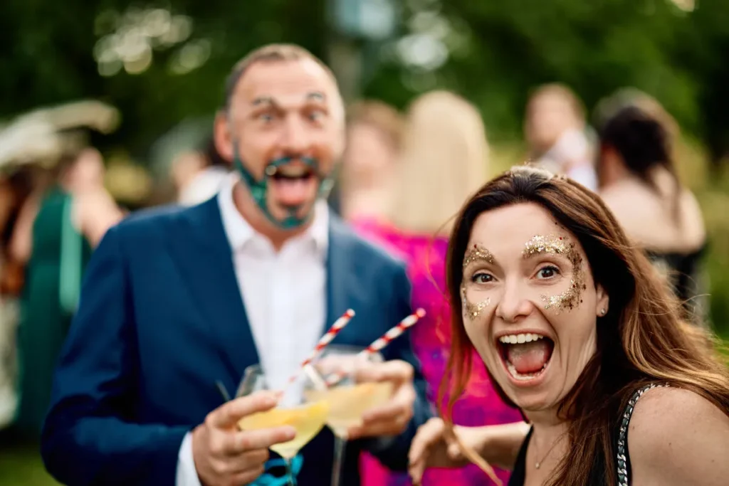 Wedding guests with their faces painted in glitter from Oh Snap UK glitter bar. Wedding entertainment fun for a relaxed informal wedding