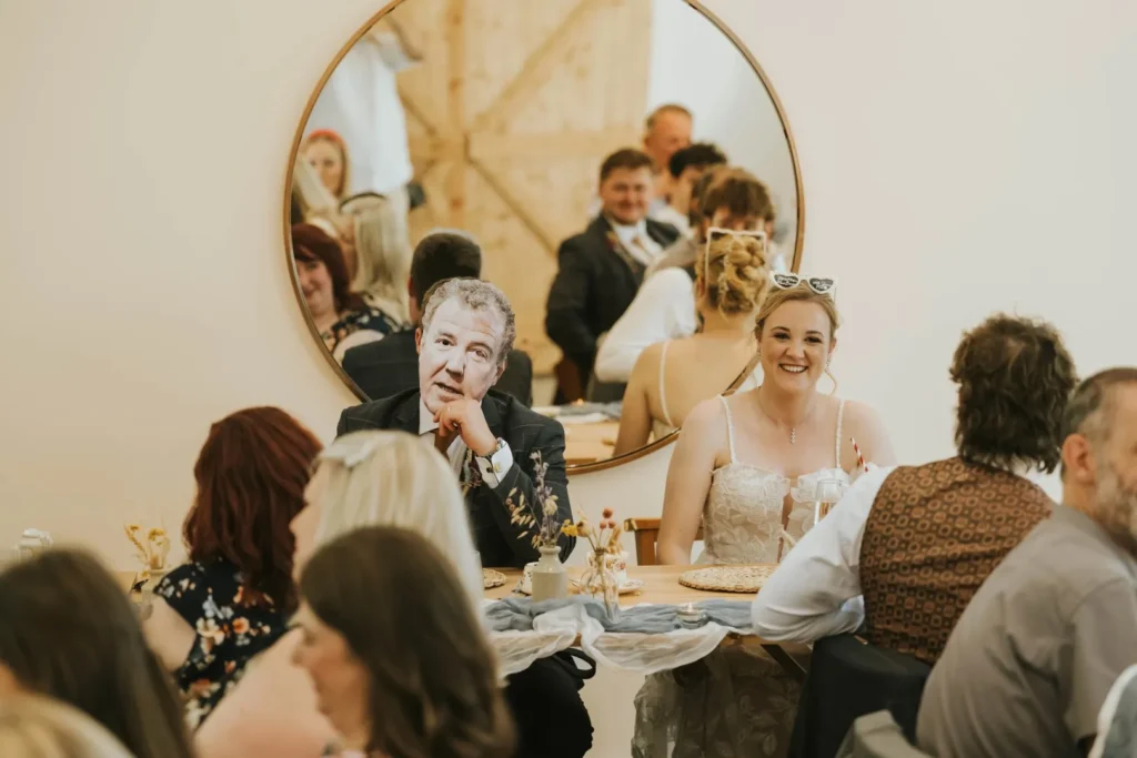 wedding couple pictured with the groom wearing a Jeremy Clarkson mask. A personal detail making the wedding fun