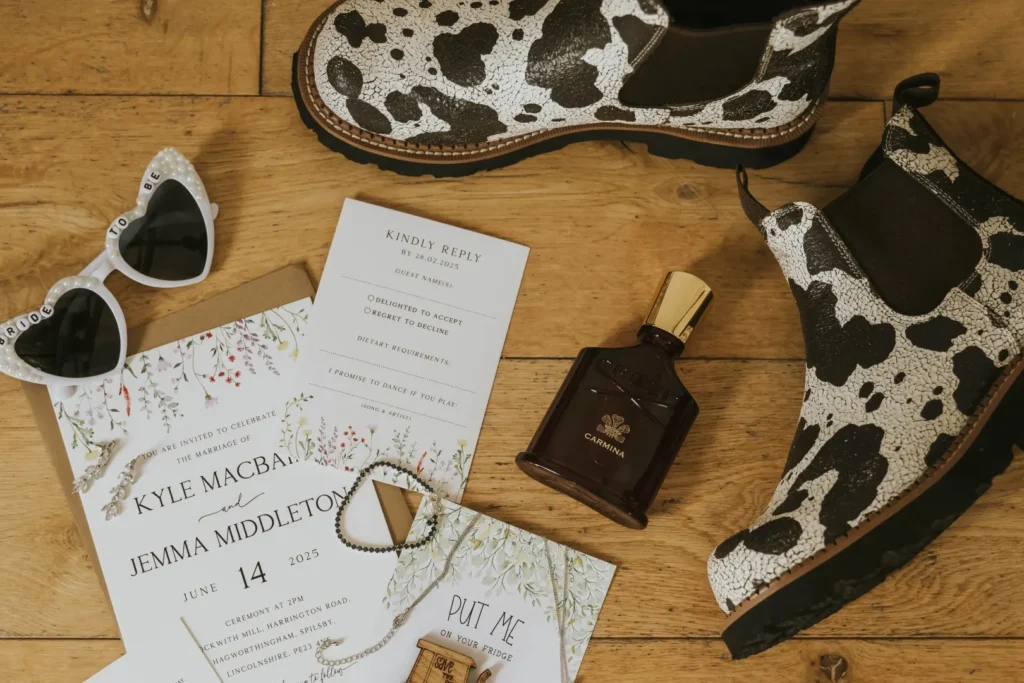 Personal wedding details like these cow print boots and personalised stationery for a relaxed, fun and informal wedding